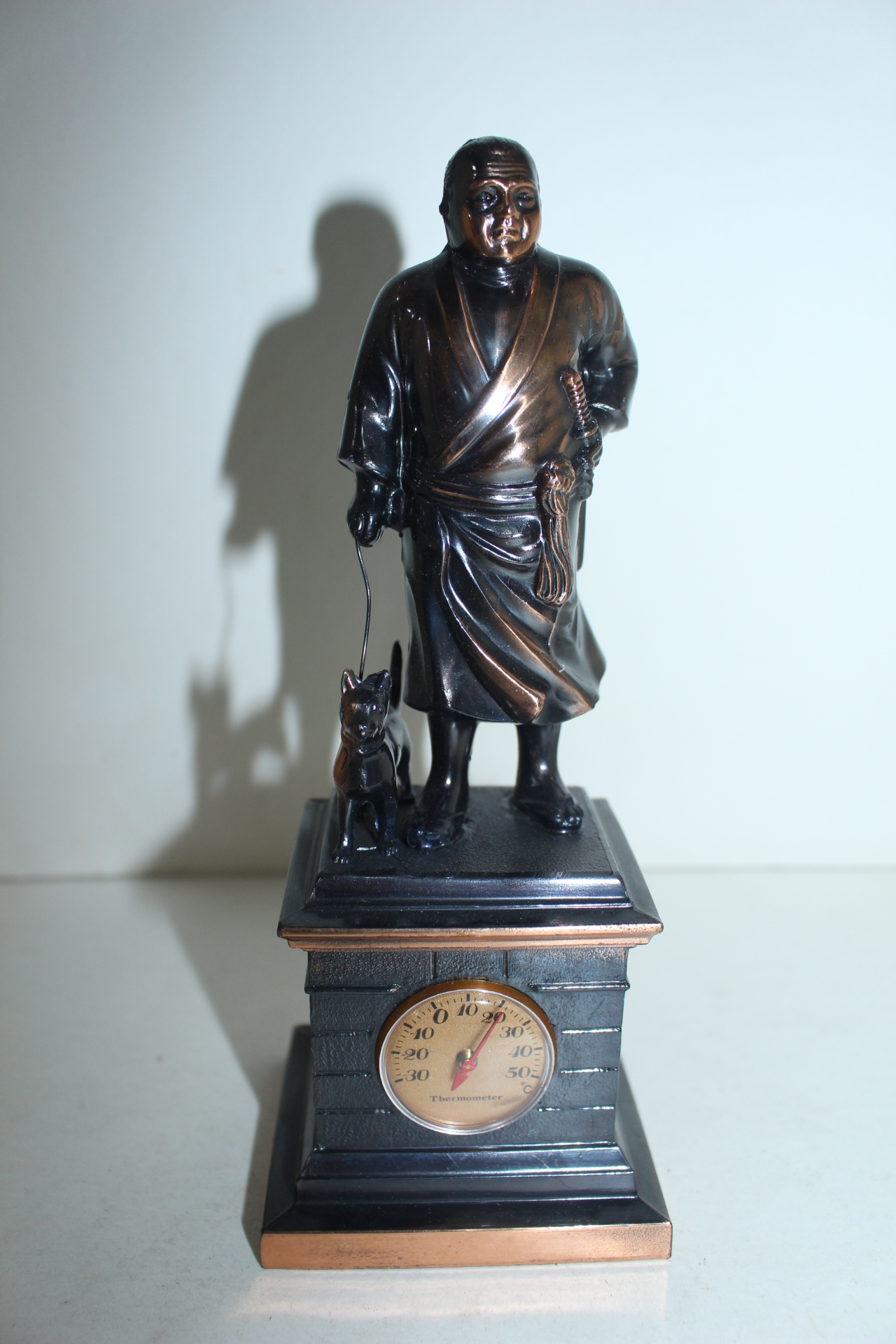 묵직한 금속재질로된 온도계가있는 인물동상 조각상