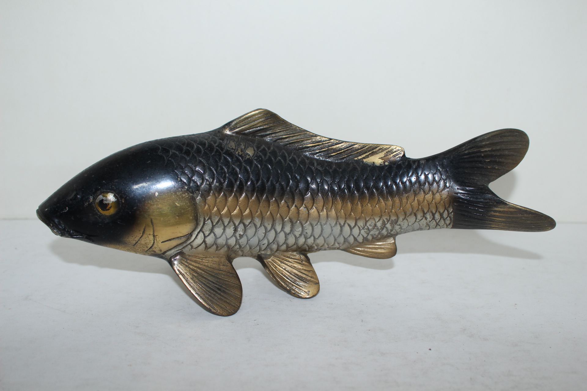 묵직한 청동으로된 작가의 작품인 물고기 조각상